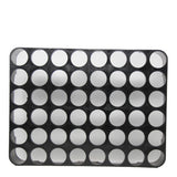 Black plastic tray with multiple round holes on a white background